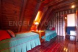 Cozy A-frame cabin with two twin beds, perfect for a relaxing getaway.