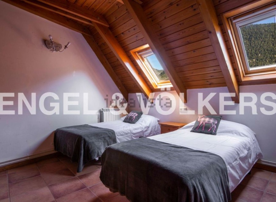 Cosy attic bedroom with twin beds and mountain views.