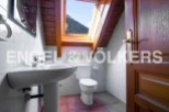 Charming attic bathroom with skylight offering mountain views.