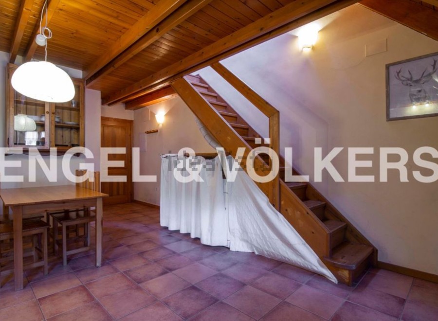 Charming chalet with wooden beams and terracotta floor tiles.