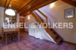 Charming chalet with wooden beams and terracotta floor tiles.