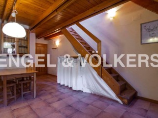 Charming chalet with wooden beams and terracotta floor tiles.