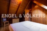 Charming attic bedroom with wooden beams and built-in wardrobes.