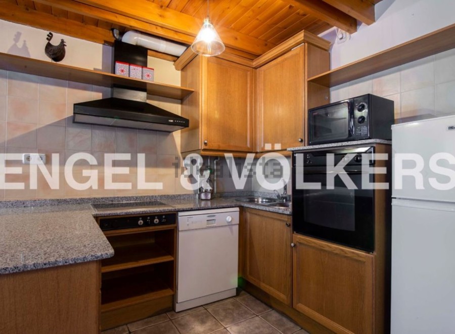 Cozy kitchen with wooden cabinets and granite countertops.