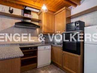 Cozy kitchen with wooden cabinets and granite countertops.