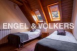 Charming attic bedroom with two twin beds, offering a cozy and comfortable space for guests.