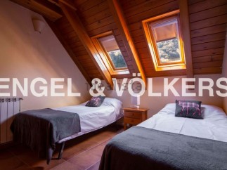 Charming attic bedroom with two twin beds, offering a cozy and comfortable space for guests.