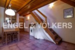 Charming chalet with wooden beams and terracotta floor tiles.