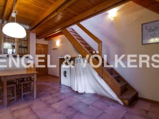 Charming chalet with wooden beams and terracotta floor tiles.
