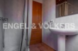 Charming bathroom with shower stall and pedestal sink.