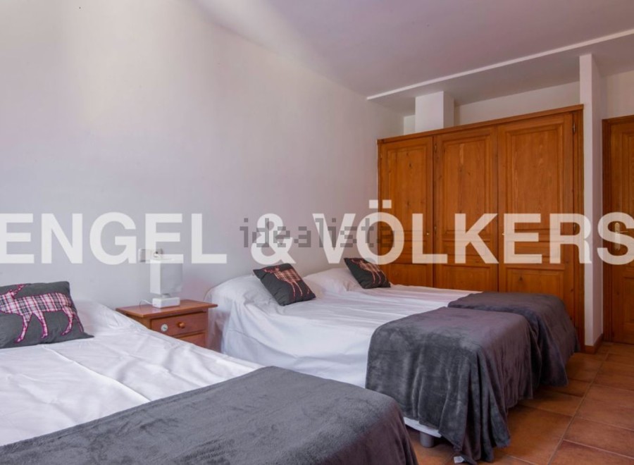 Cozy bedroom with three twin beds, perfect for families or groups.