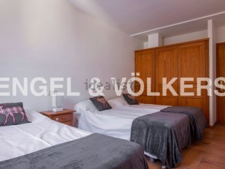 Cozy bedroom with three twin beds, perfect for families or groups.
