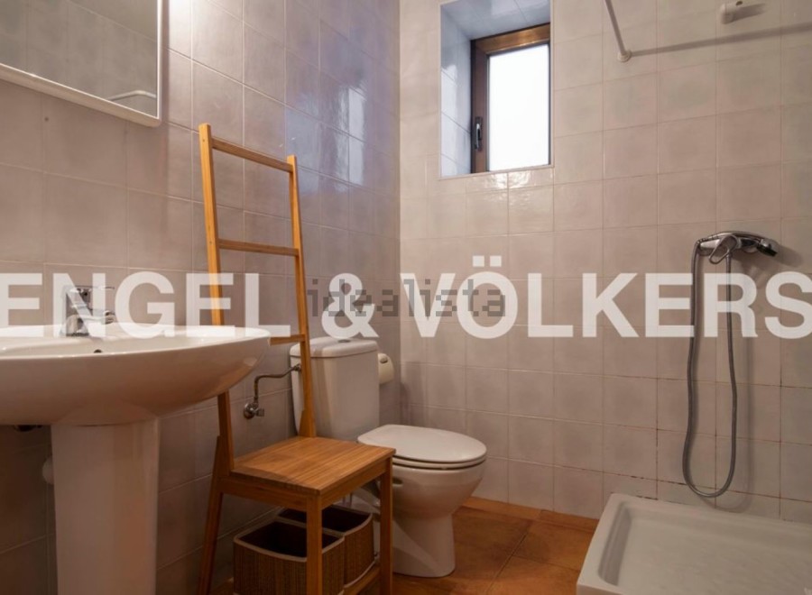 Charming bathroom with a pedestal sink, toilet, and shower.