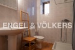 Charming bathroom with a pedestal sink, toilet, and shower.