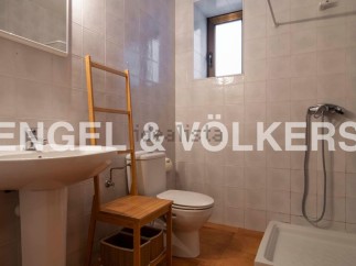 Charming bathroom with a pedestal sink, toilet, and shower.