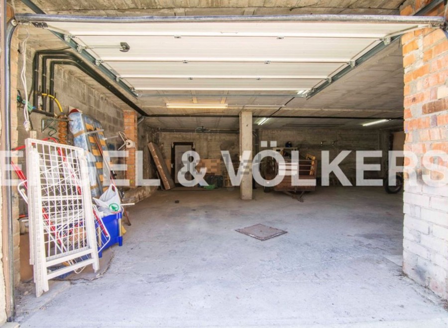 Spacious garage with ample storage space, perfect for parking and storing belongings.