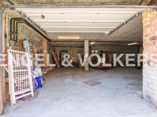 Spacious garage with ample storage space, perfect for parking and storing belongings.