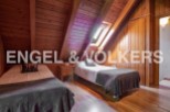 Charming attic bedroom with twin beds and wooden beams.