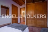 Charming bedroom with wooden floors and built-in wardrobe.