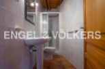 Charming bathroom with pedestal sink and shower stall.