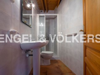 Charming bathroom with pedestal sink and shower stall.