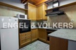 Cozy kitchen with wooden cabinets, granite countertops, and integrated appliances.