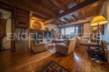 Rustic mountain home with stunning wooden beams, hardwood floors, and a cozy fireplace.