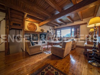 Rustic mountain home with stunning wooden beams, hardwood floors, and a cozy fireplace.