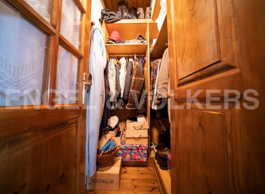 Charming wooden wardrobe with ample storage space for coats, shoes, and accessories.