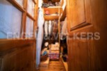 Charming wooden wardrobe with ample storage space for coats, shoes, and accessories.