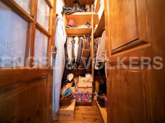 Charming wooden wardrobe with ample storage space for coats, shoes, and accessories.