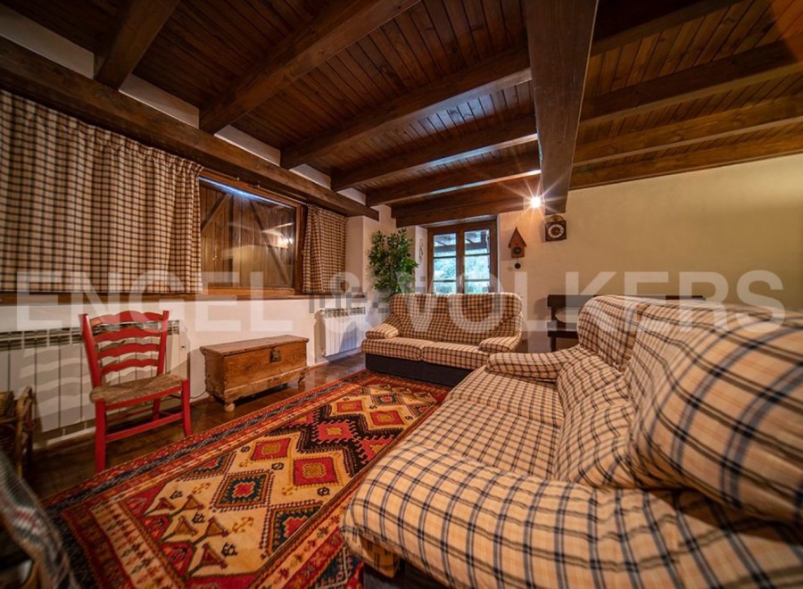 Cozy living room with wooden beams and a rustic feel.
