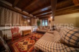 Cozy living room with wooden beams and a rustic feel.