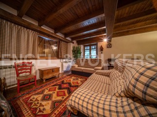Cozy living room with wooden beams and a rustic feel.
