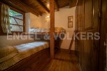 Cozy rustic bedroom with wooden bunk beds and built-in storage, perfect for a relaxing getaway.