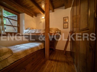 Cozy rustic bedroom with wooden bunk beds and built-in storage, perfect for a relaxing getaway.