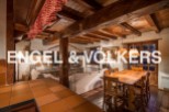 This stunning chalet boasts a spacious open-plan living area with exposed wooden beams and a cozy fireplace, perfect for relaxing after a day on the slopes.