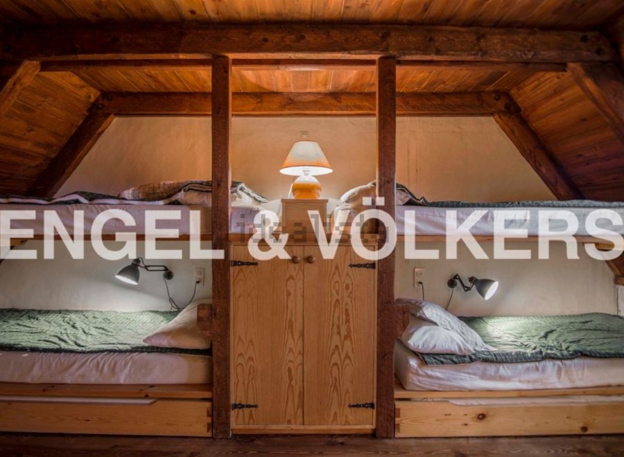 Cozy attic room with twin bunk beds, perfect for a family or friends getaway.