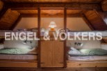 Cozy attic room with twin bunk beds, perfect for a family or friends getaway.