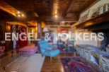 Rustic mountain home with exposed wooden beams, a large stone fireplace, and ample living space.