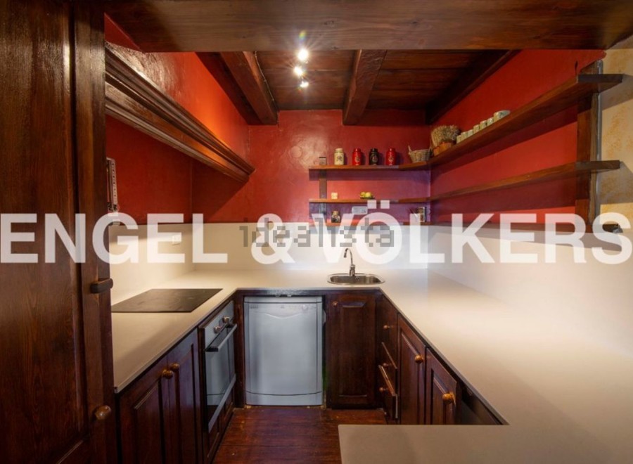 Charming rustic kitchen with wooden cabinetry and countertops.