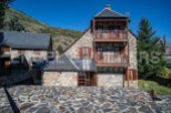 This charming stone house boasts two levels with balconies, offering stunning mountain views.