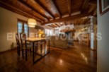 Rustic mountain home with exposed wooden beams, a cozy fireplace, and a spacious open-plan living area.