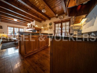 This stunning property boasts a beautiful wooden kitchen with granite countertops and custom cabinetry.