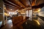 This stunning chalet boasts a spacious open-plan living area with exposed wooden beams and a cozy fireplace.