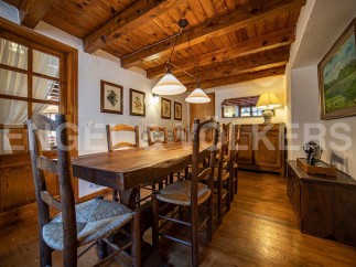 Rustic wooden dining table taking center stage in this charming country home.