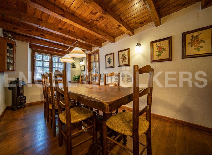 Rustic wooden dining table with charming straw chairs, perfect for enjoying meals in a cozy atmosphere.