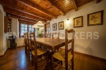 Rustic wooden dining table with charming straw chairs, perfect for enjoying meals in a cozy atmosphere.