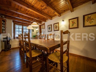 Rustic wooden dining table with charming straw chairs, perfect for enjoying meals in a cozy atmosphere.