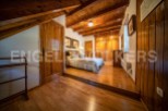 This charming bedroom boasts a rustic wooden interior with exposed beams and hardwood floors.